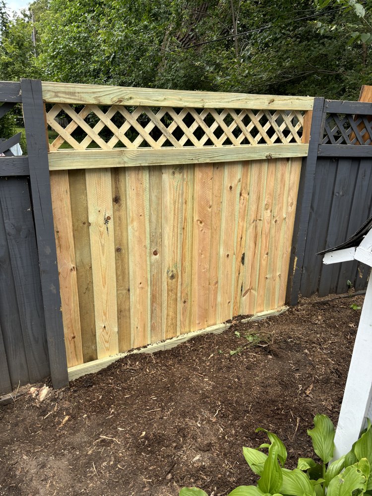 Lattice-top cedar privacy panel matched to an existing fence