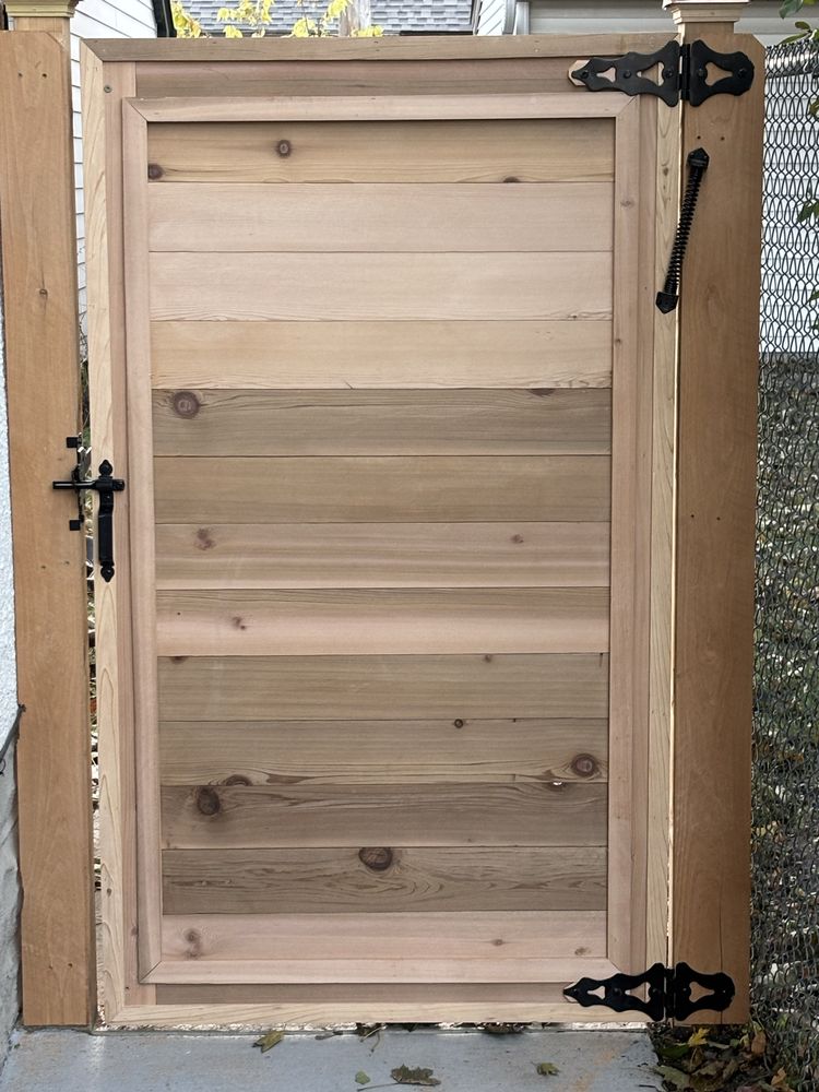 Custom cedar walk gate with black strap hinges built by A Couple Fence and Repair Guys